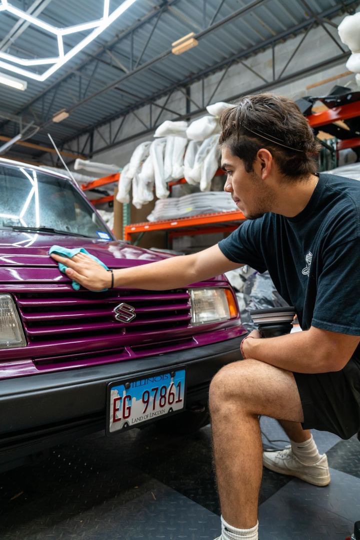 Professional detailing of a purple Sidekick car's paint, enhancing its high-gloss finish with meticulous cleaning, performed in Aurora, Illinois
