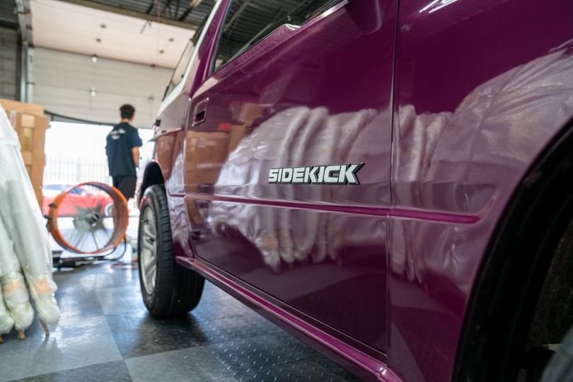 Side view of the purple Sidekick car, showcasing its high-gloss detailed paint finish, expertly detailed in Aurora, Illinois.