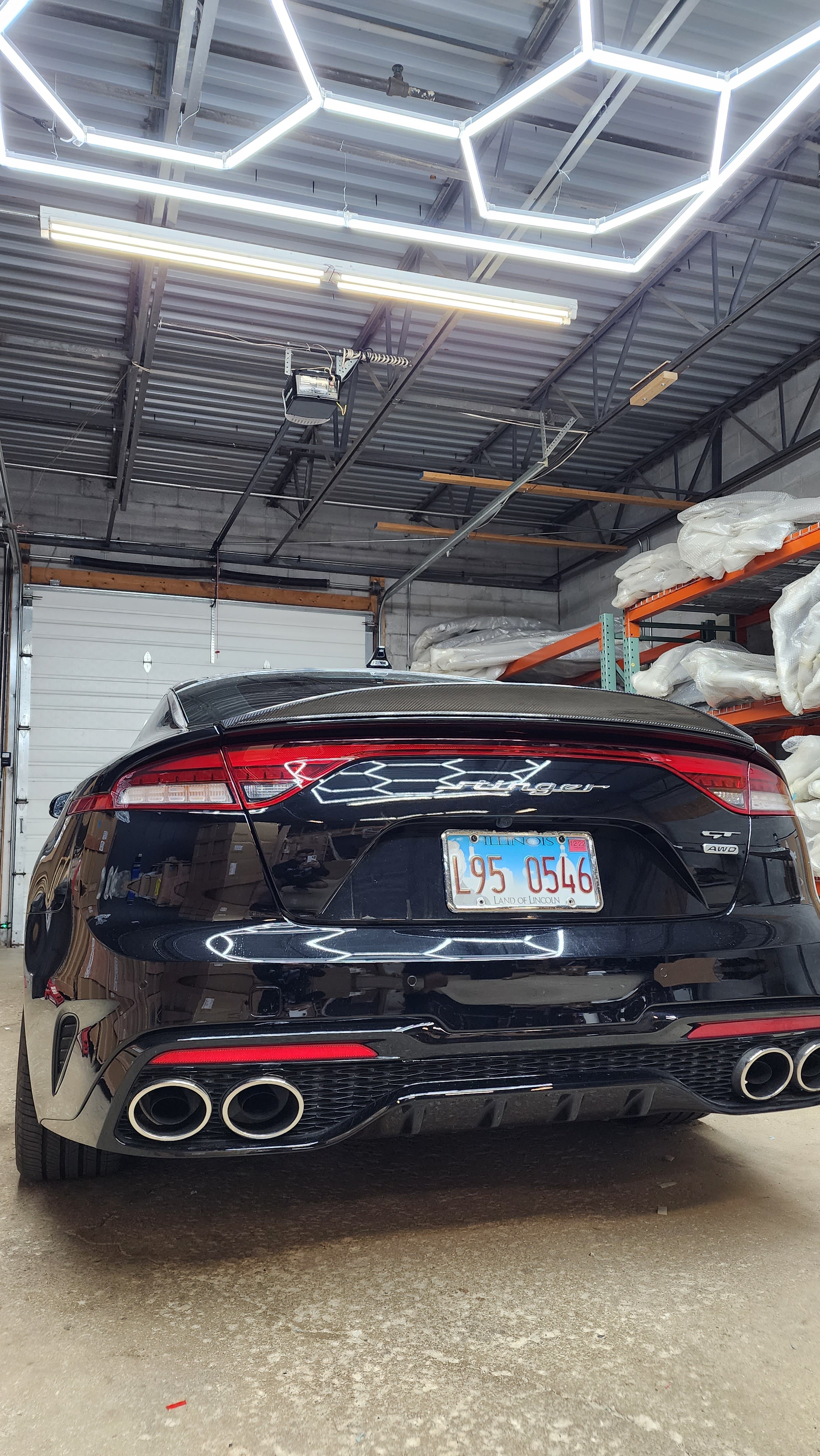 Direct rear view of the Kia Stinger featuring Jalisco's CF Duckbill Spoiler, emphasizing the spoiler's impact on the car's overall rear profile and its aerodynamic shape