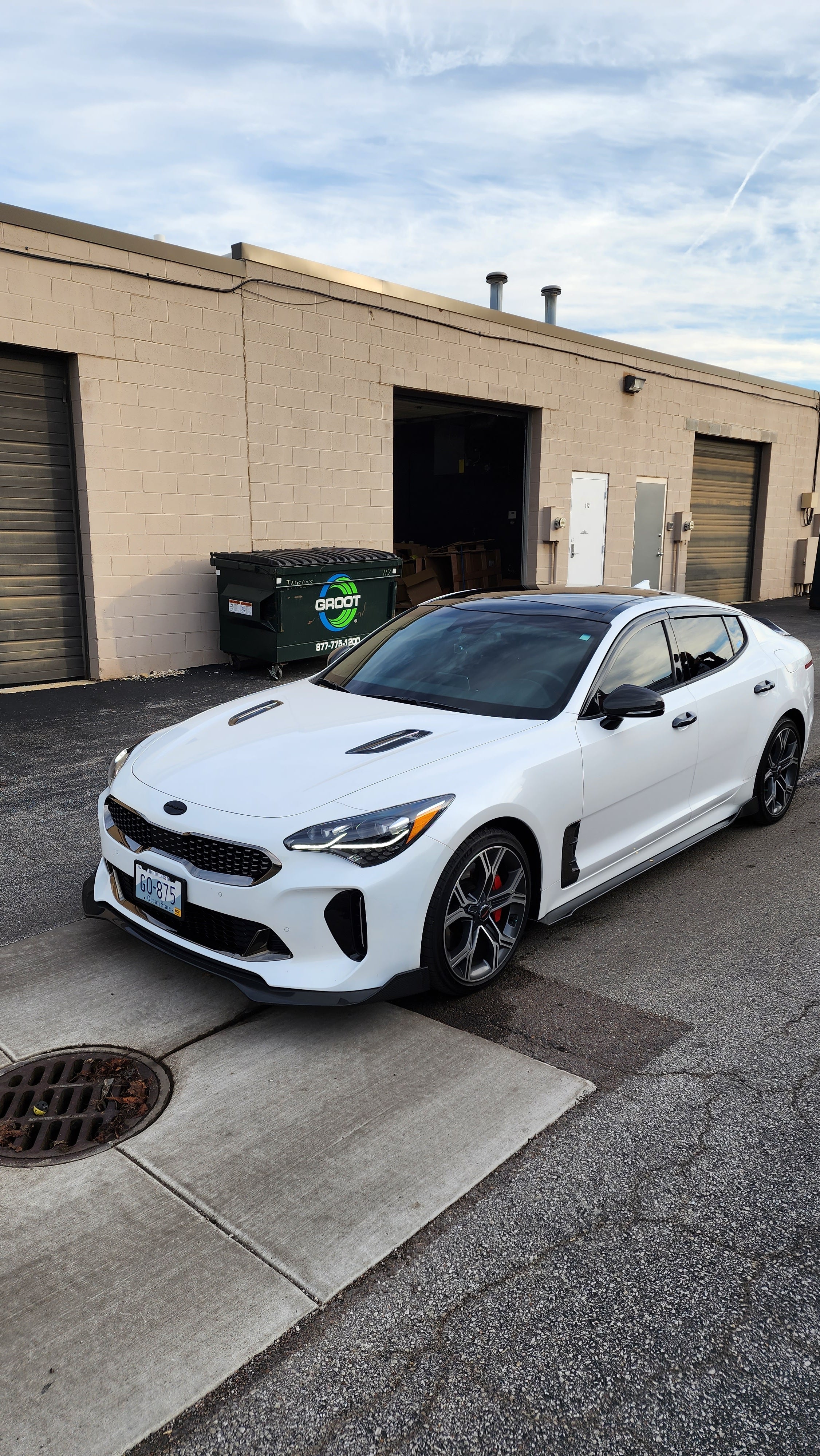Direct front view of the Kia Stinger equipped with Jalisco's CarbonFiber Front Lip, focusing on the lip's integration with the car's overall design