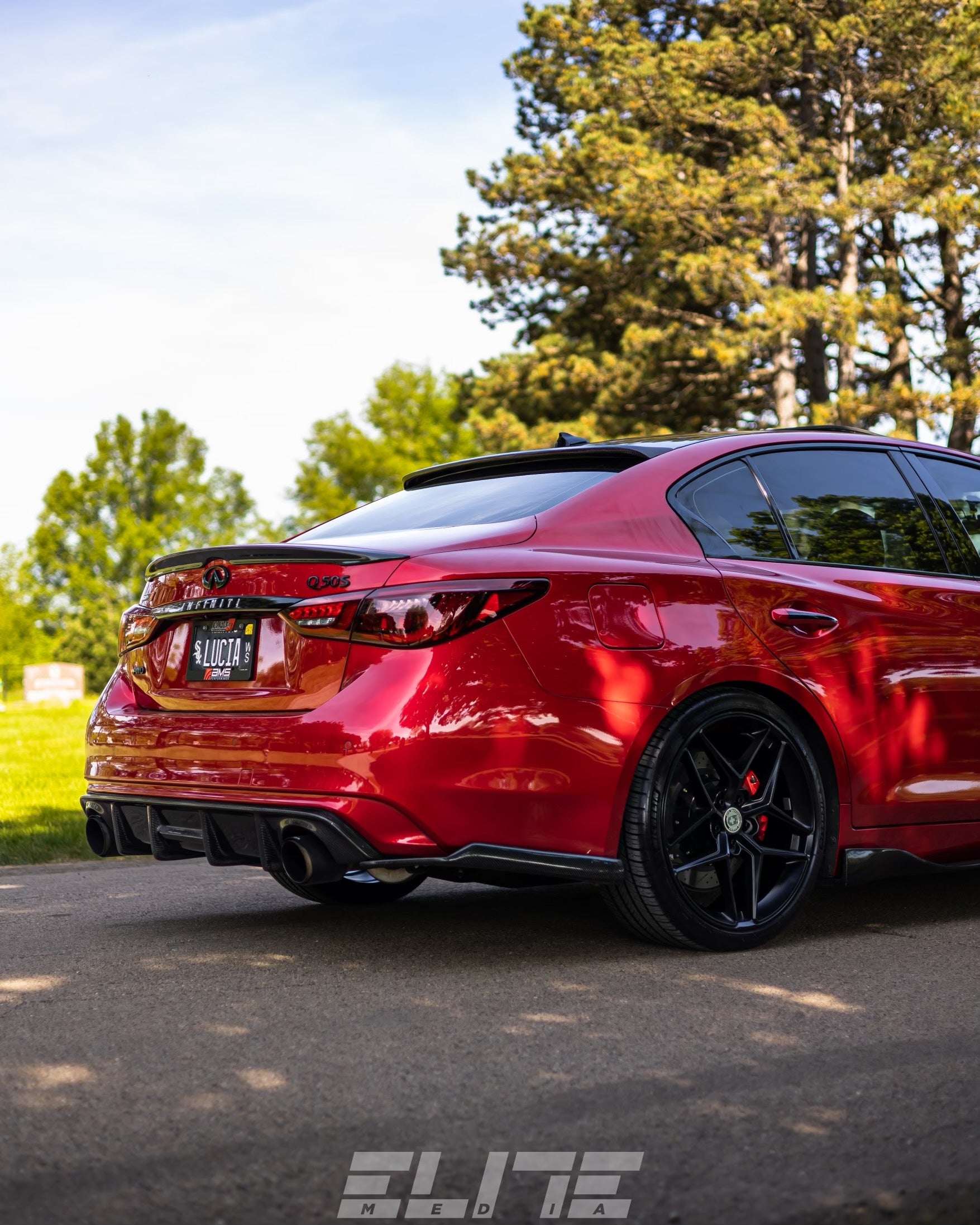 Stunning professional shot emphasizing the elegance and design of Jalisco's CF Carbon Fiber 'OG' Style Diffuser on a red Infiniti Q50 2018.