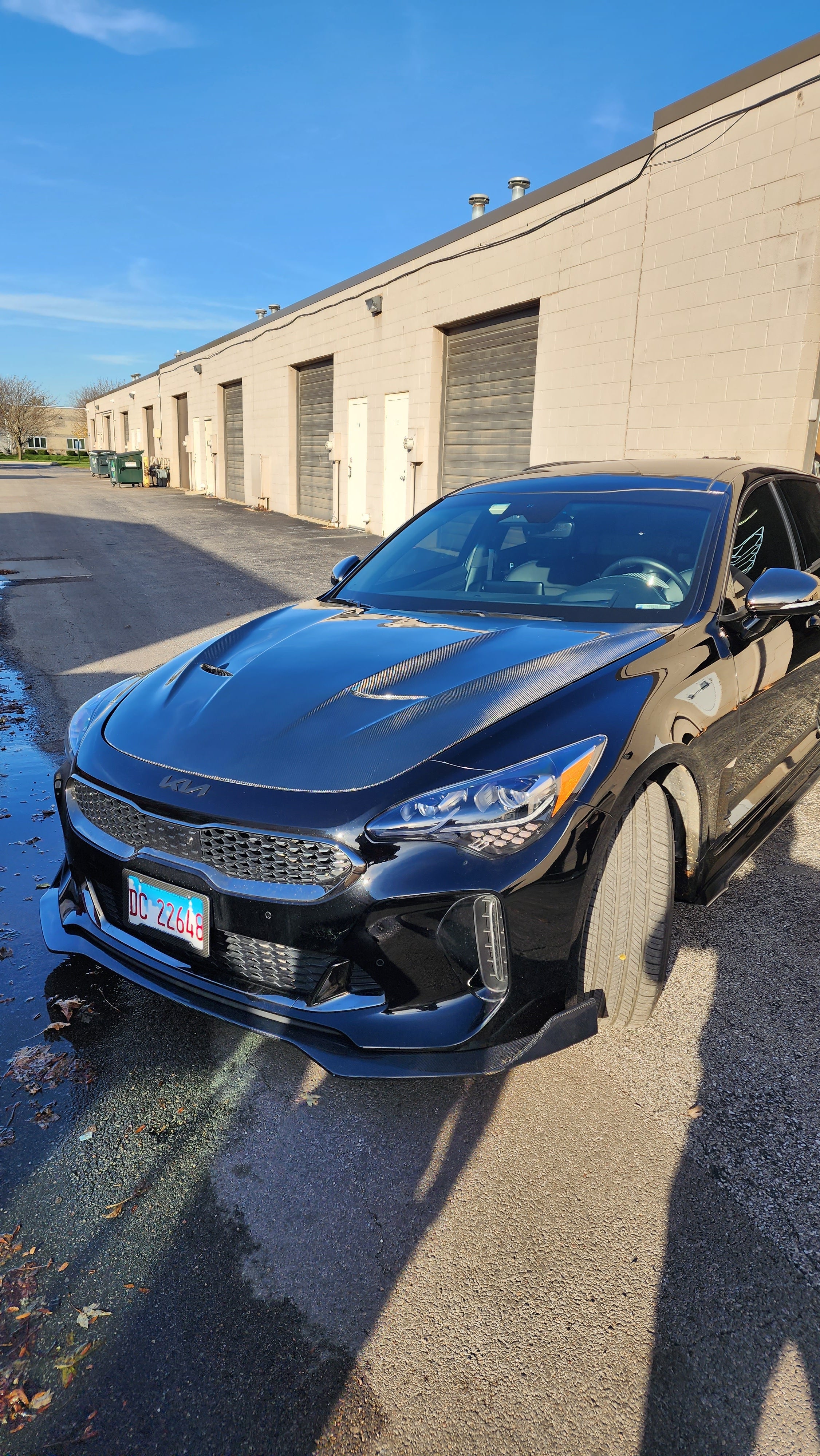 Full front perspective of the KIA STINGER equipped with the 'JCF' Carbon Fiber Hood, showing the overall impact on the car's front-end aesthetics.
