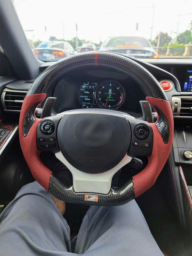 Steering wheel with red and black cover in a car interior