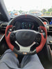 Steering wheel with red and black cover in a car interior