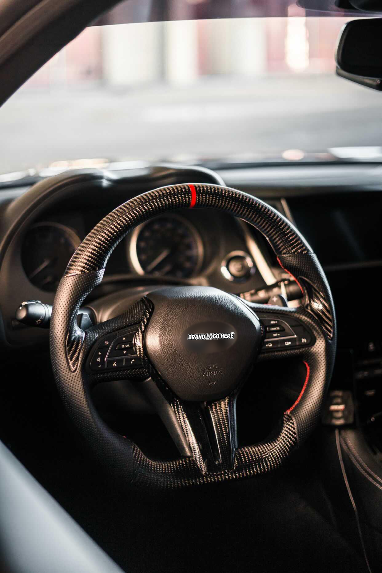 Professional wide-angle shot of Jalisco's carbon fiber steering wheel with red stripe and leather grip for Infiniti Q50/Q60