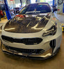 Angled front view of the KIA STINGER with Jalisco's Carbon Fiber Hood, emphasizing its aerodynamic profile and sporty appearance.