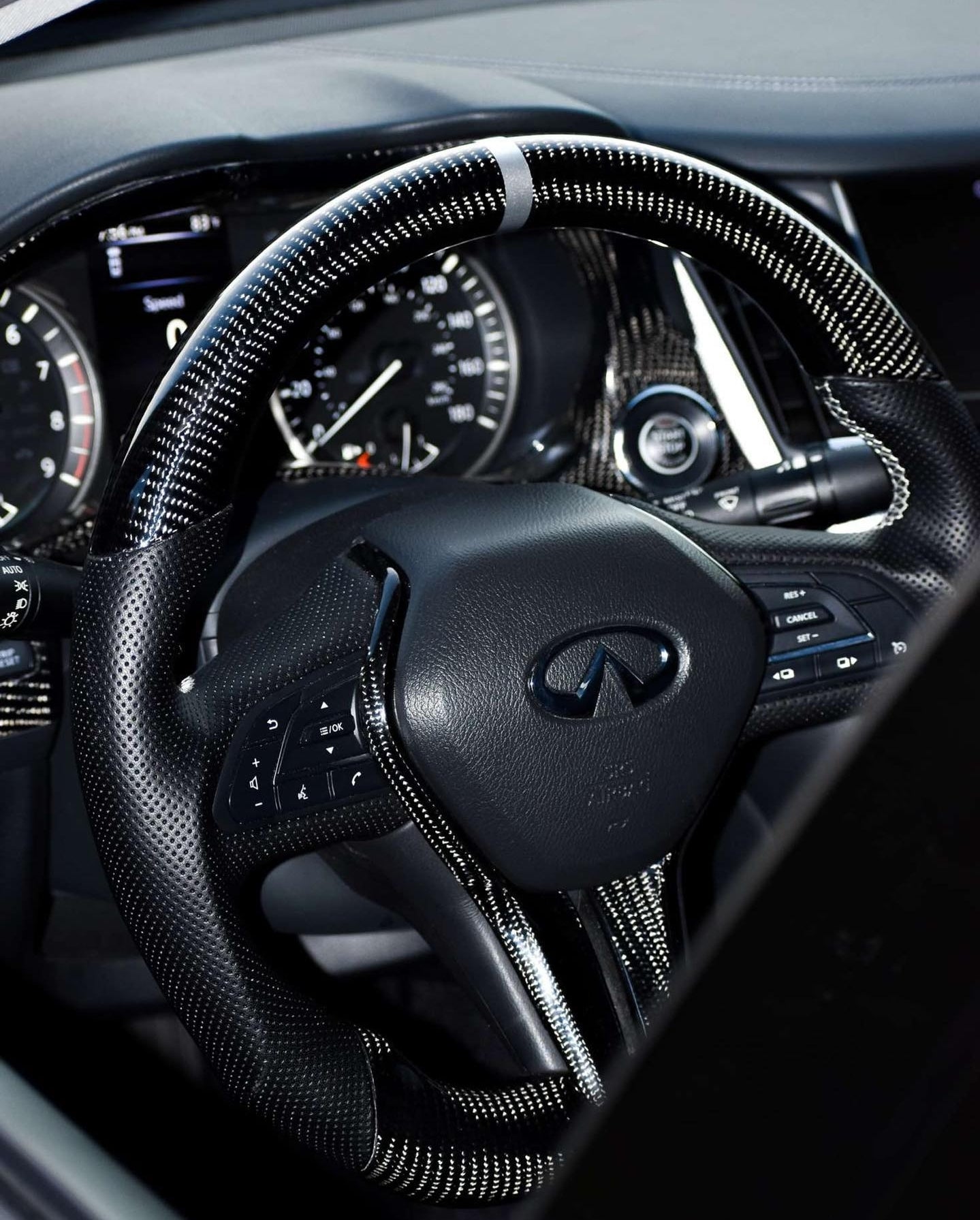 Wide shot of Jalisco's dark carbon fiber steering wheel with white stripe for Infiniti Q50/Q60.