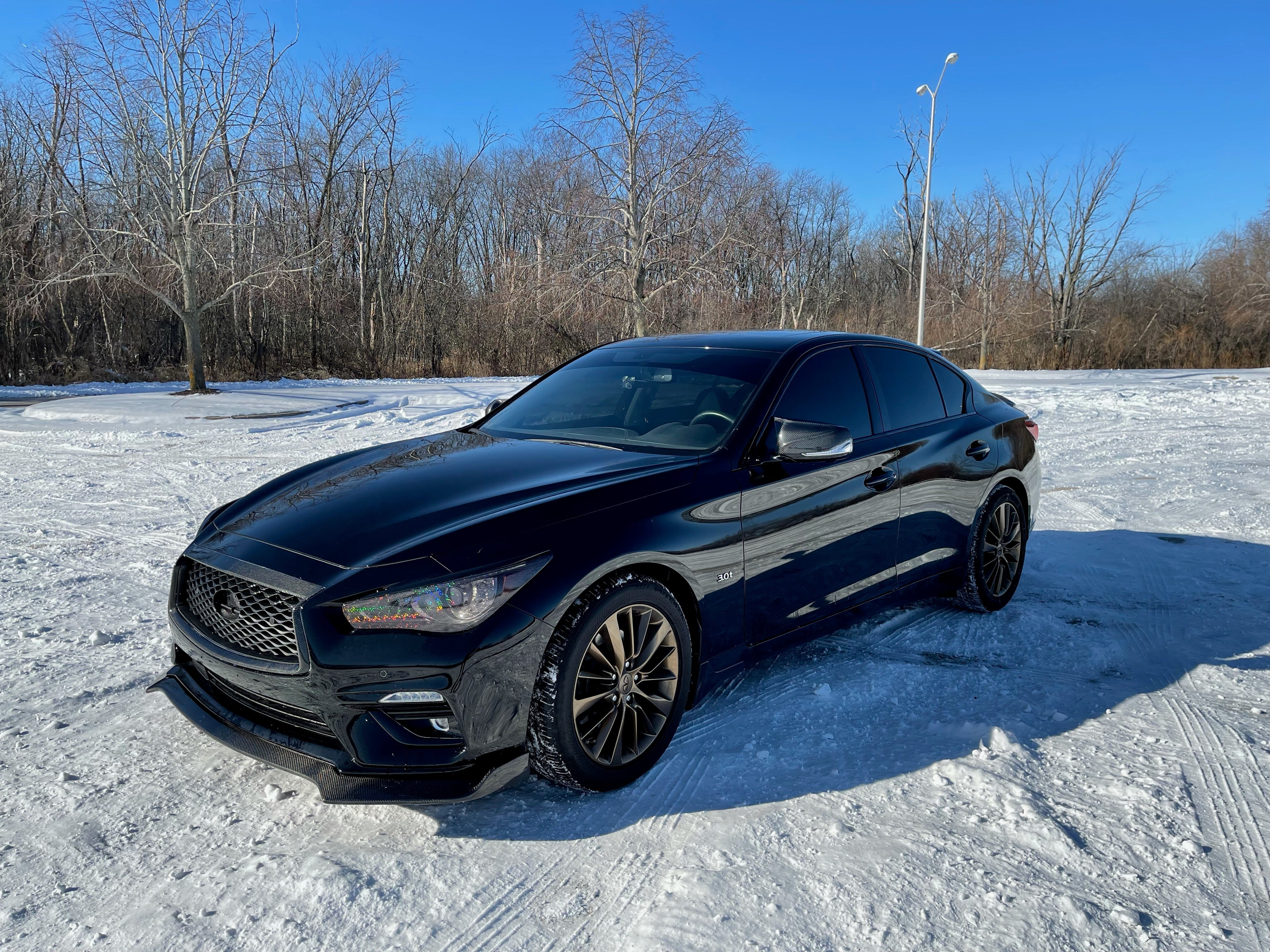 Installation view of JCF Front Lip Splitter on Q50, demonstrating the enhancement of vehicle aesthetics.