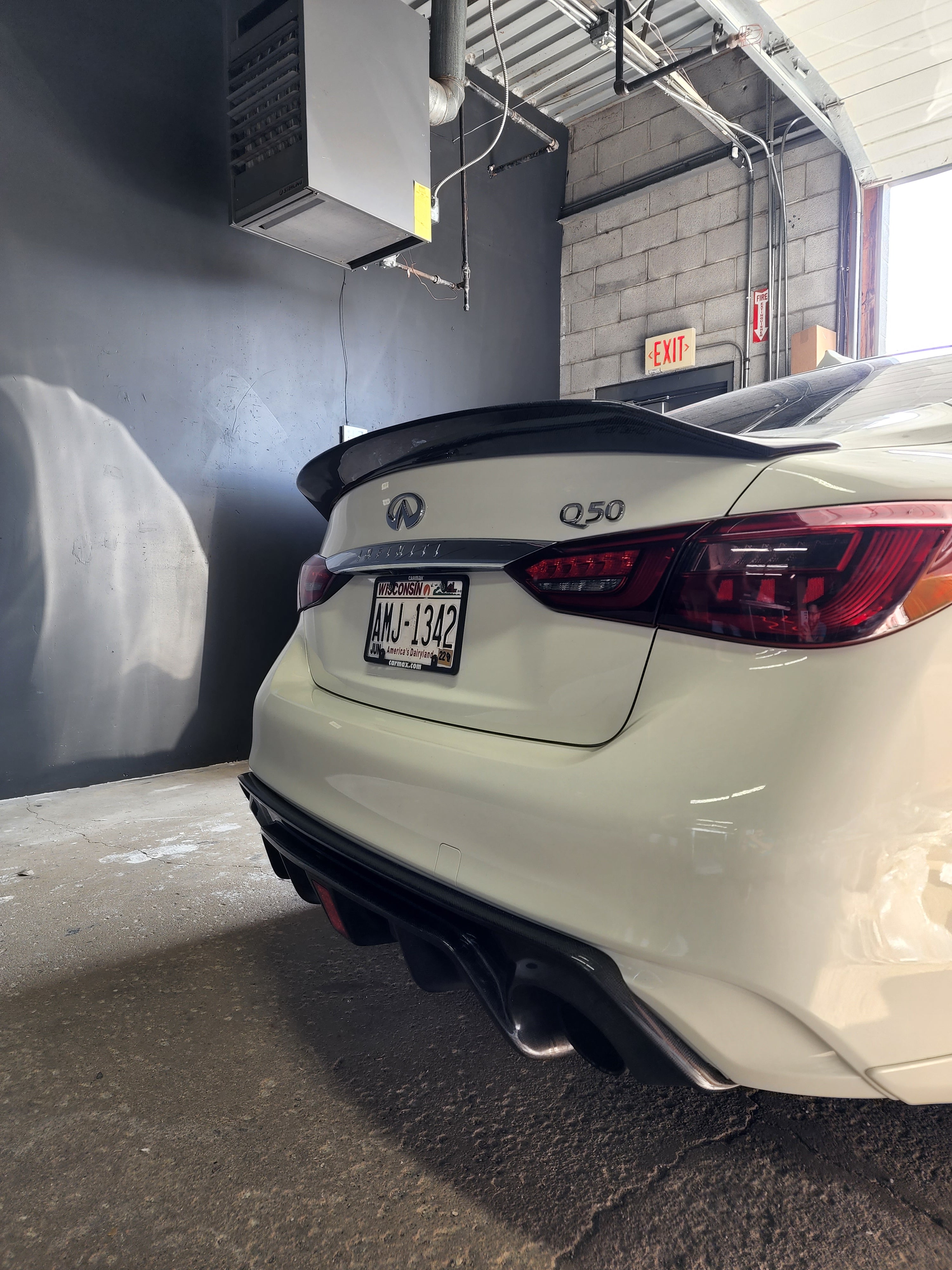 Angled view of the Infiniti Q50 featuring Jalisco's Carbon Fiber V2 Duckbill Spoiler, emphasizing its guaranteed fitment.