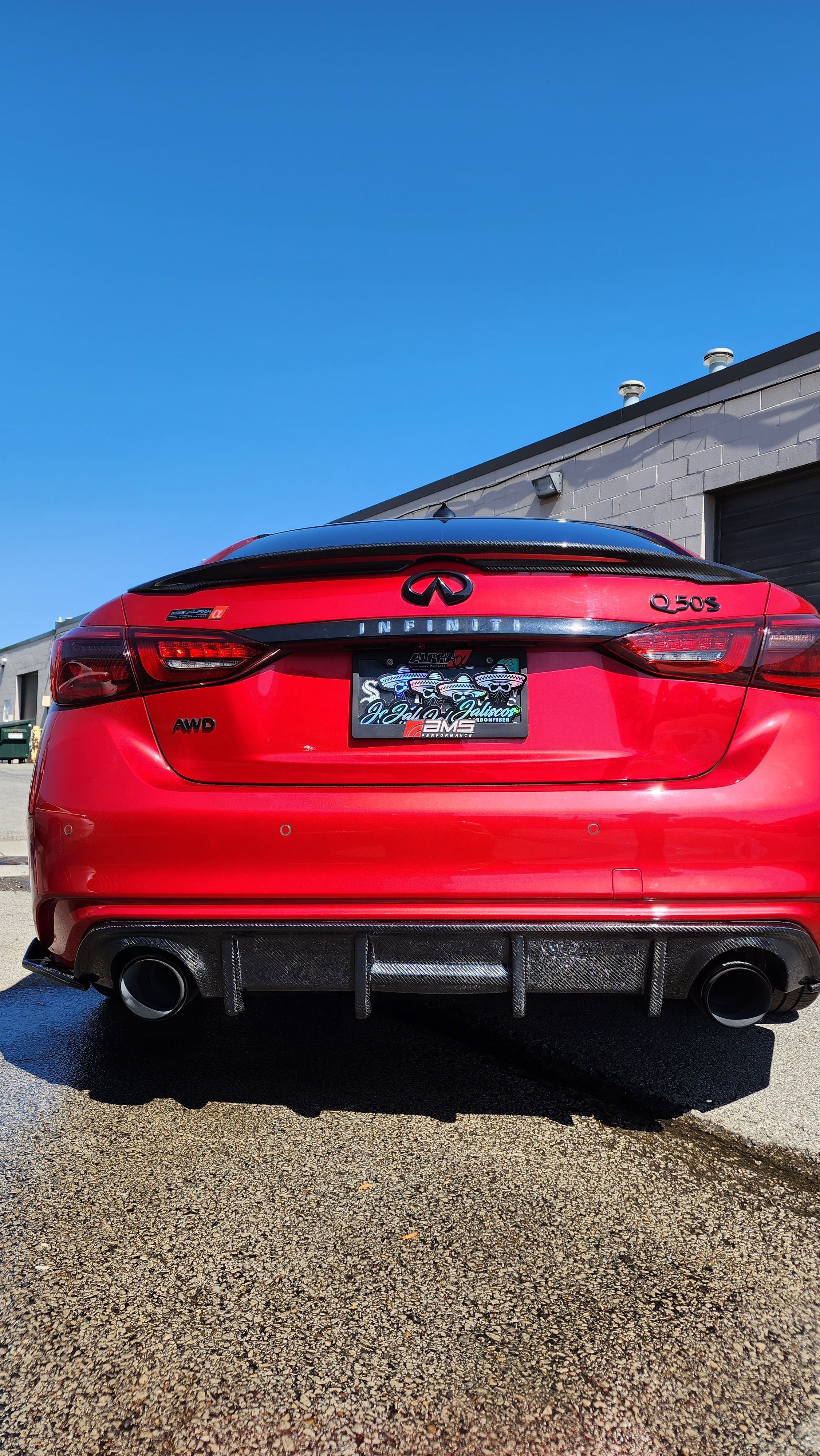 Red Infiniti Q50 2018, detailed view of Jalisco's CF Carbon Fiber 'OG' Style Diffuser from a distinct angle.