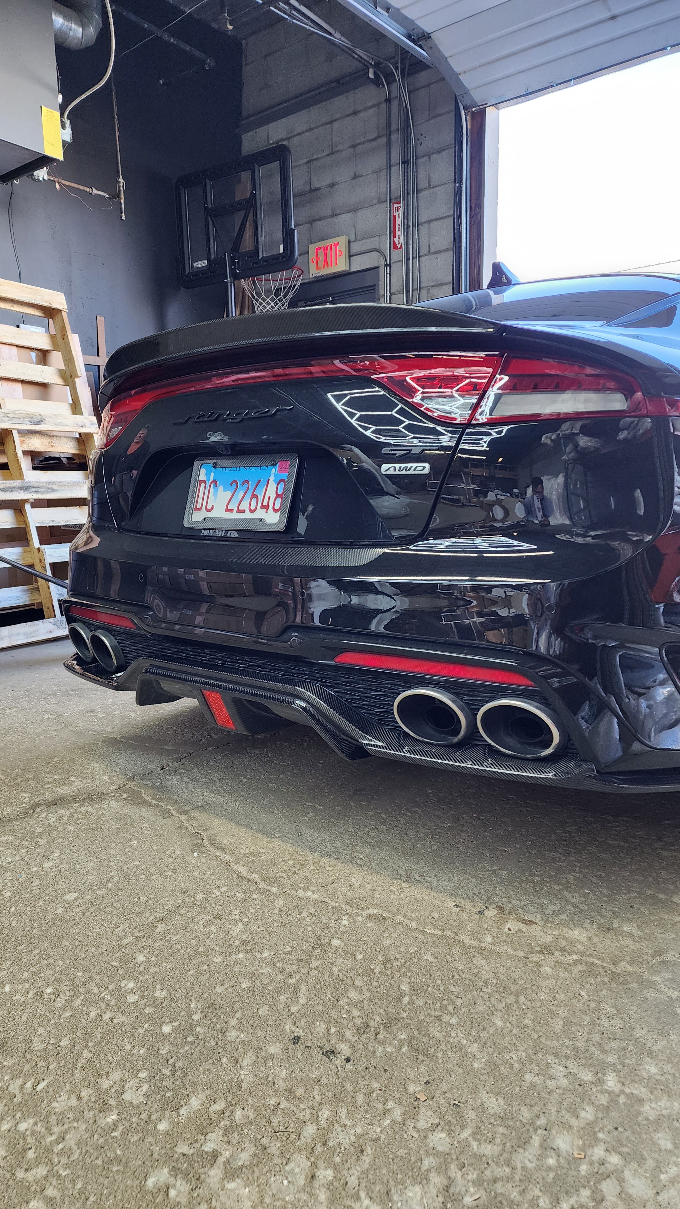 Angled rear perspective of the KIA STINGER with the Carbon Fiber Diffuser, showcasing how it enhances the vehicle's sporty aesthetic