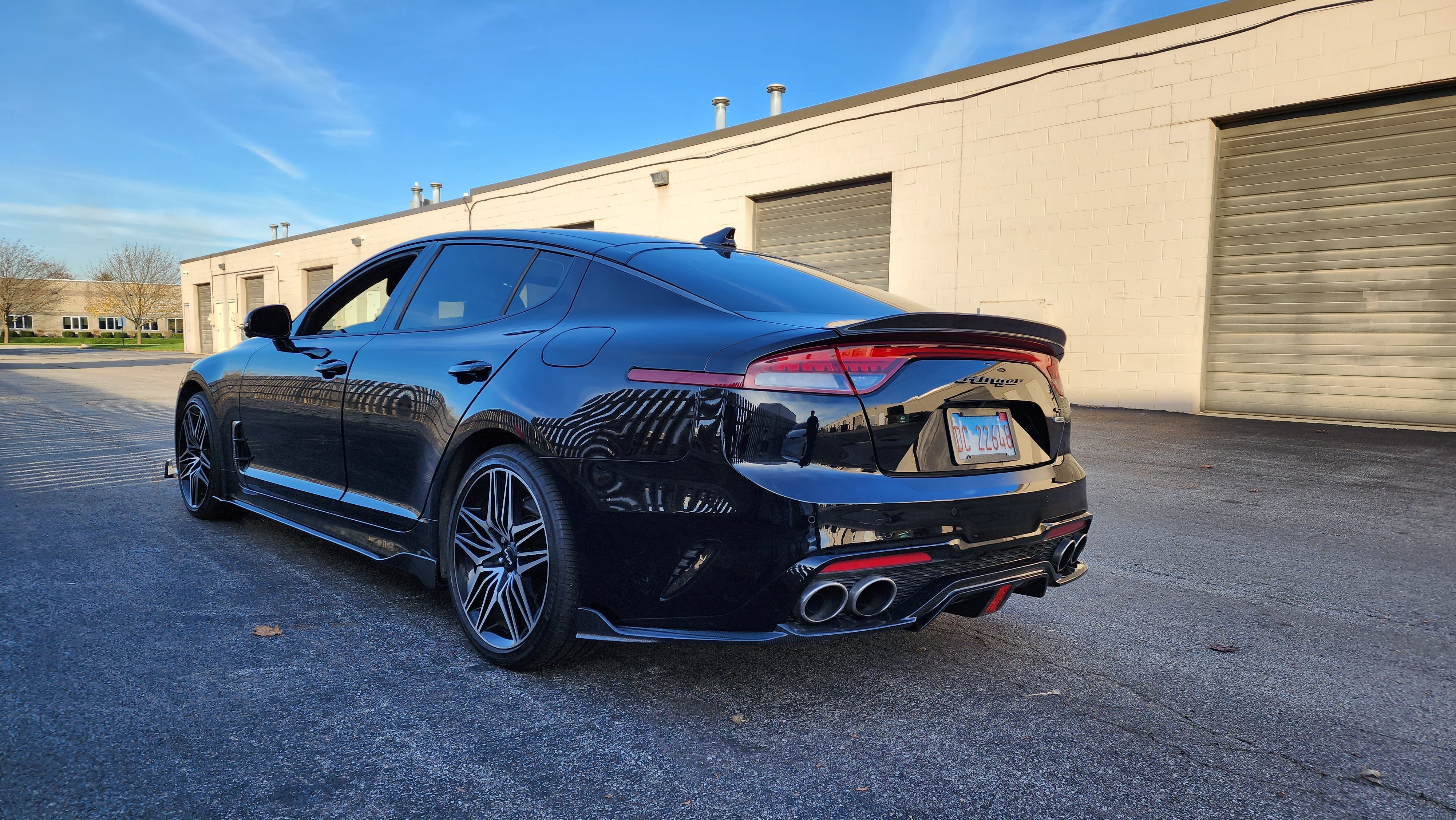 Overall rear shot of the KIA STINGER featuring the 2022' Carbon Fiber Diffuser, capturing the enhanced aggressive stance and styling.