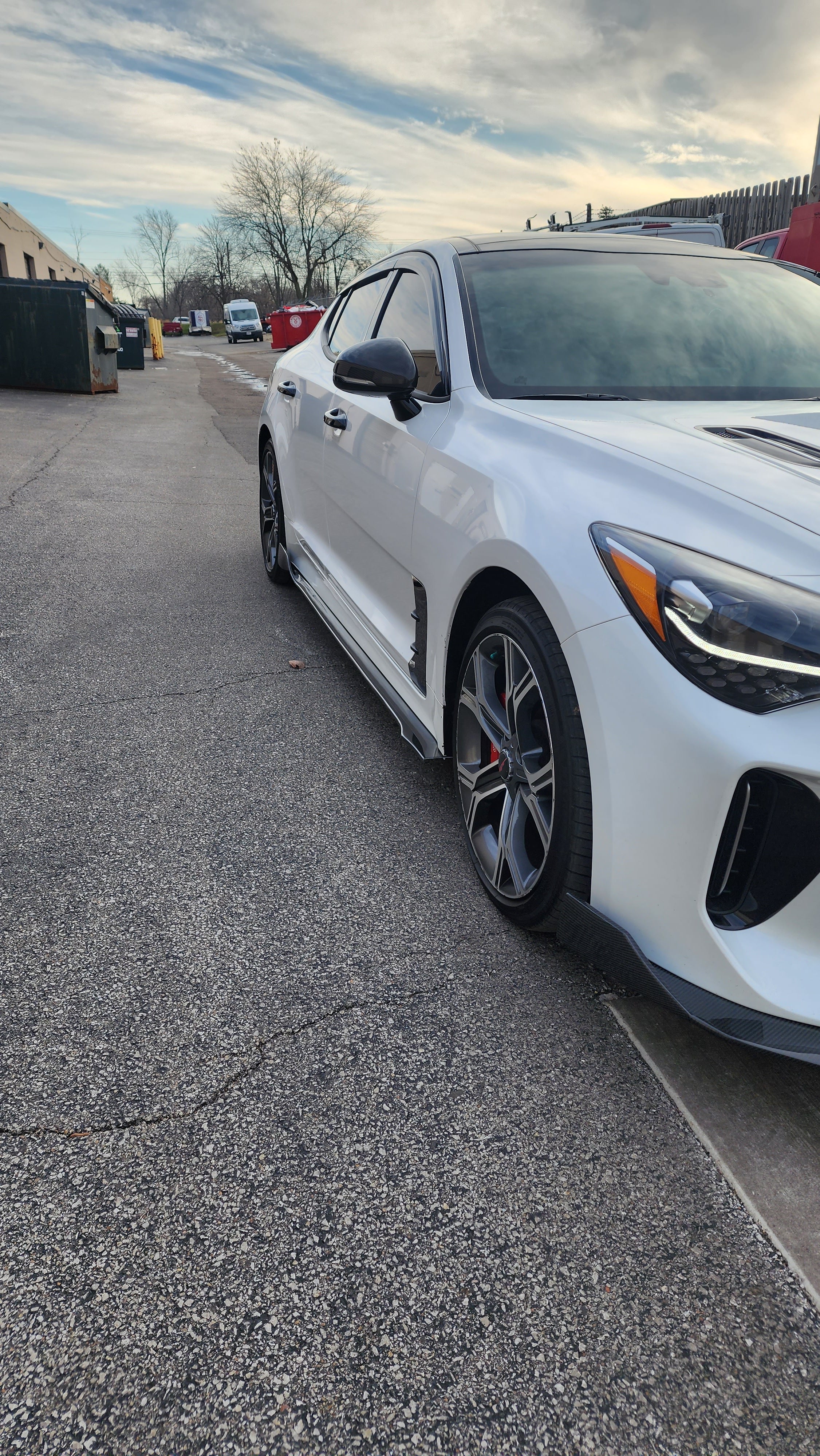 Wide shot of the Kia Stinger featuring the Jalisco CF Side Skirts, capturing the enhanced dynamic and aggressive stance provided by the skirts.