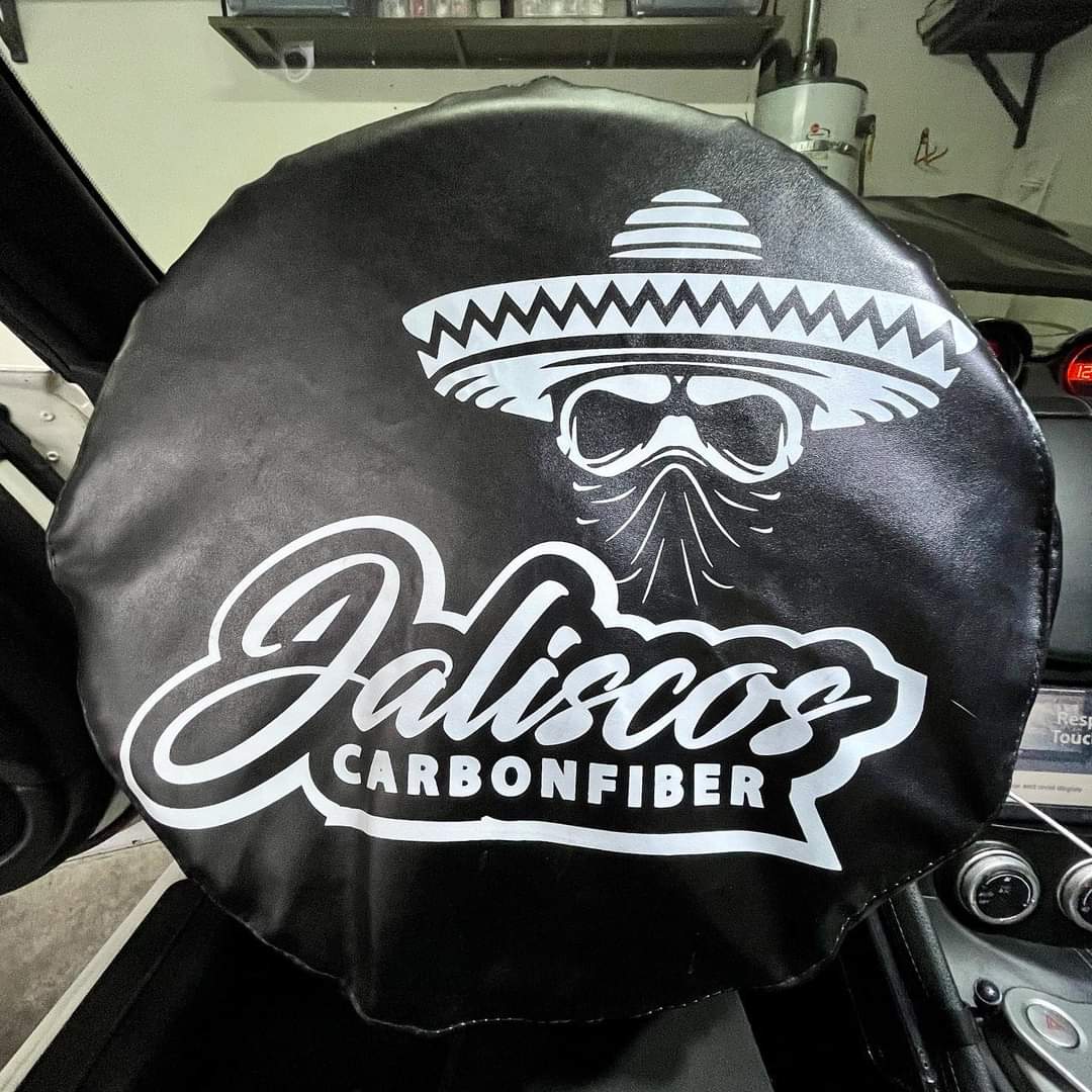 Steering wheel cover showcasing Jalisco's carbon fiber logo.