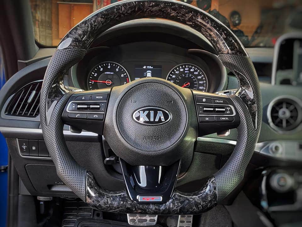 Image of the JCF Carbon Fiber Steering Wheel designed for the KIA STINGER GT, displaying its sleek carbon fiber finish and ergonomic design. The wheel features a modern, sporty look, suitable for heated steering wheel models, and showcases the superior craftsmanship and attention to detail that JCF is known for