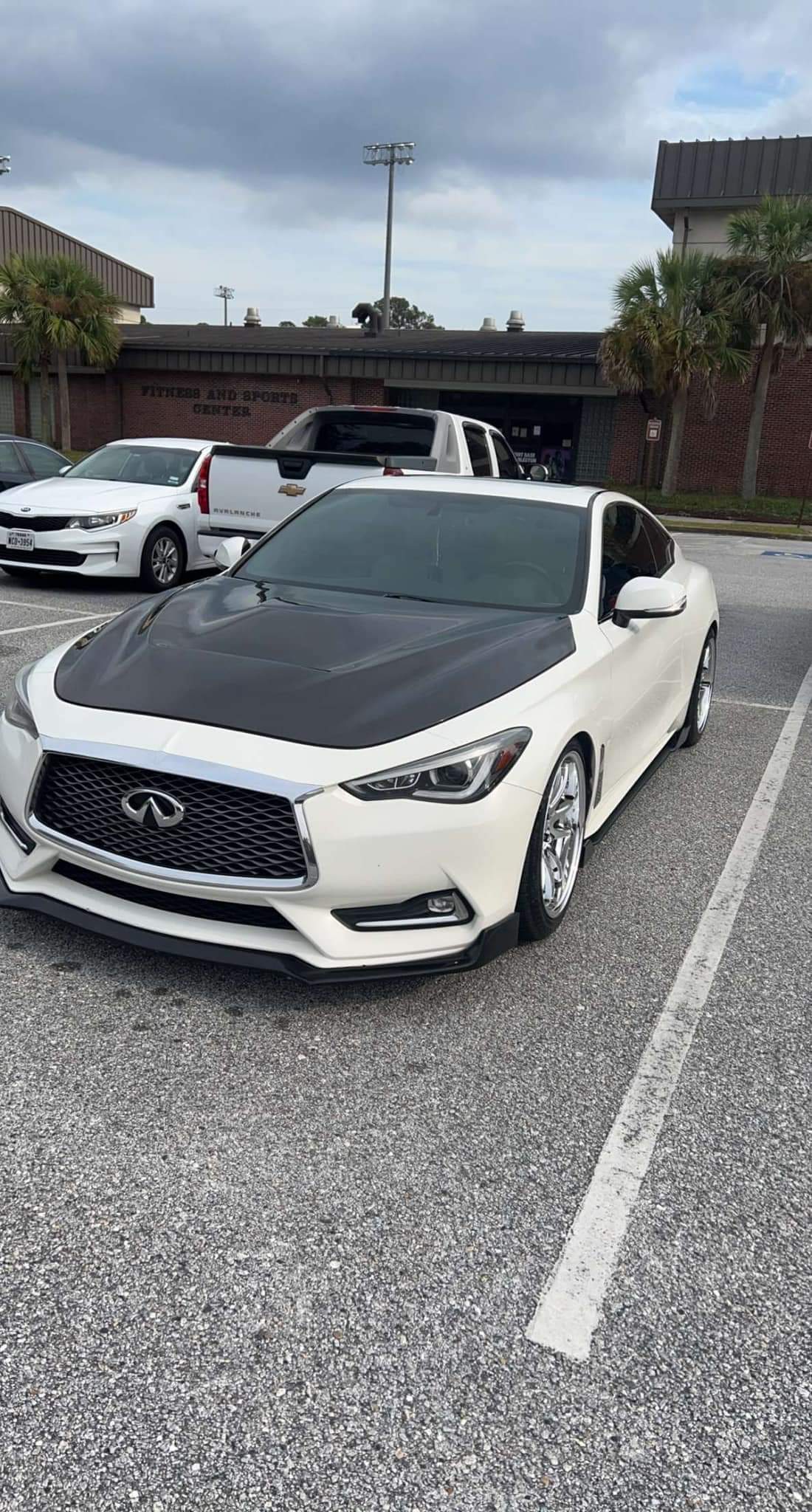 Q60 with the hood open, showing the underside of the JCF Carbon Fiber Hood and its sturdy construction.