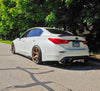 Load image into Gallery viewer, White Q50 sedan in a forest setting, equipped with Jalisco&#39;s carbon fiber diffuser.