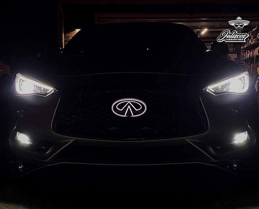 Front view of Infiniti Q60 showcasing Jalisco's LED Logo-Emblem illuminated in white.