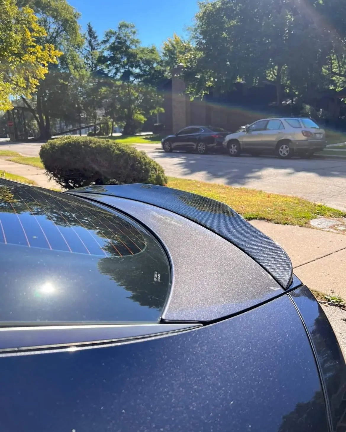 angled side view of the KIA STINGER's Duckbill Spoiler, capturing the distinctive curvature and design that complements the car’s styling