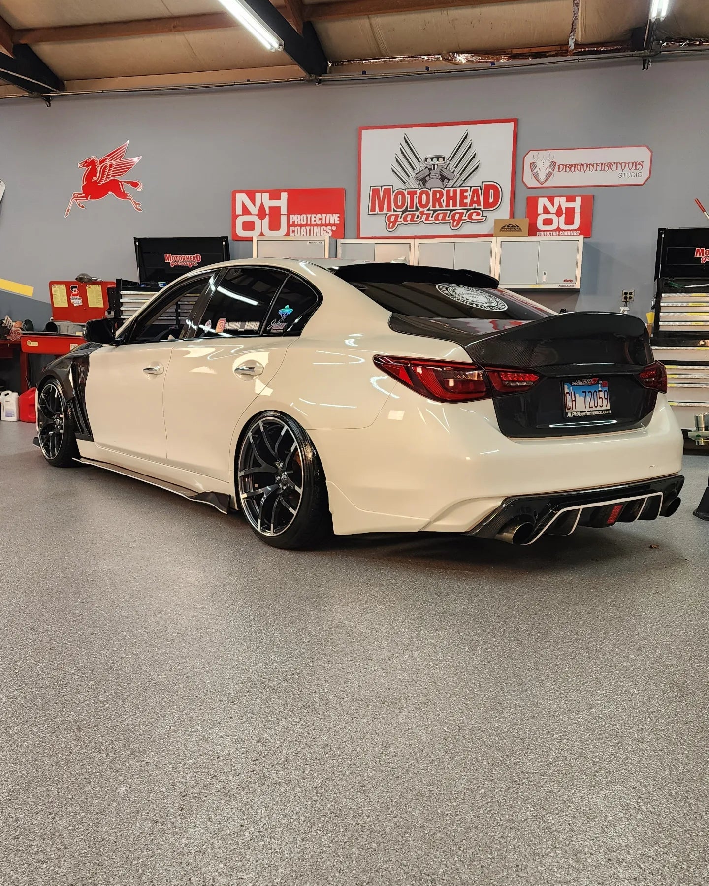 Pair of JCF Carbon Fiber Fenders designed for Q50 14-21+ models, emphasizing the high-quality carbon weave.