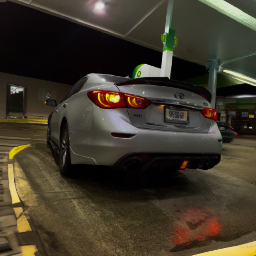 Q50 2018+ model at a gas station, showcasing its sleek design and detailing