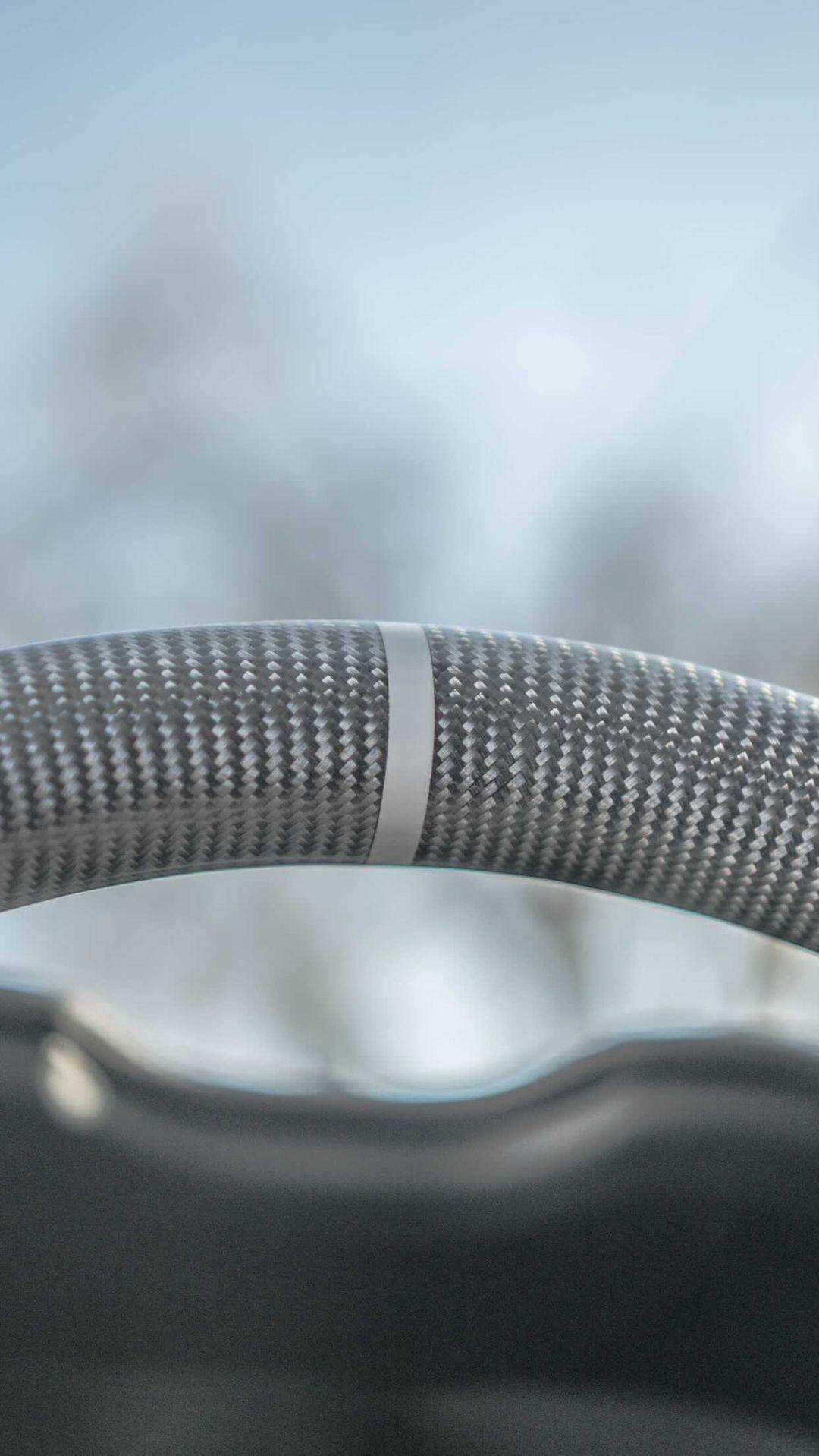Close-up shot capturing the intricate details of a gray stripe on Jalisco's CarbonFiber Steering Wheel.