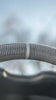 Load image into Gallery viewer, Close-up shot capturing the intricate details of a gray stripe on Jalisco&#39;s CarbonFiber Steering Wheel.